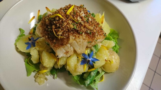 Cod with herb sourdough crumb, lemon butter potatoes and garden vegetables